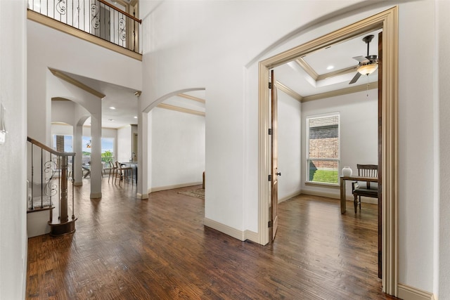 647 Gillon Way, Rockwall, TX 75087 - hall featuring arched walkways, healthy amount of natural light, crown molding, wood finished floors, and baseboards