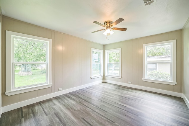 841 20th St SE, Paris, TX 75460 - empty room with baseboards, wood finished floors, and a ceiling fan