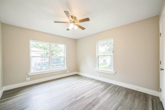 841 20th St SE, Paris, TX 75460 - unfurnished room featuring wood finished floors, a ceiling fan, and baseboards