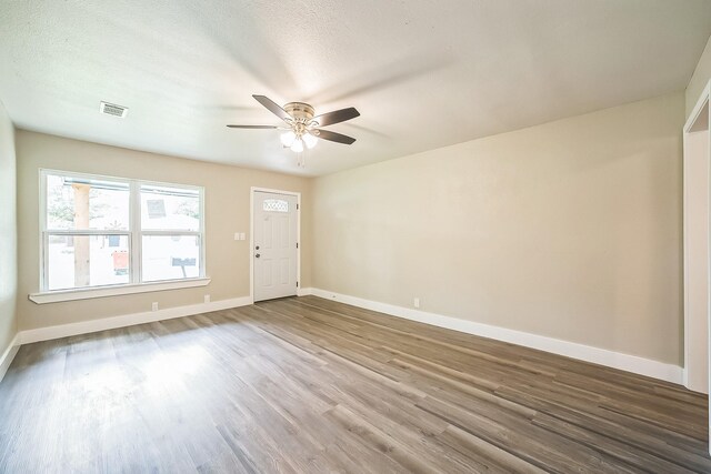 841 20th St SE, Paris, TX 75460 - empty room with ceiling fan, wood finished floors, and baseboards