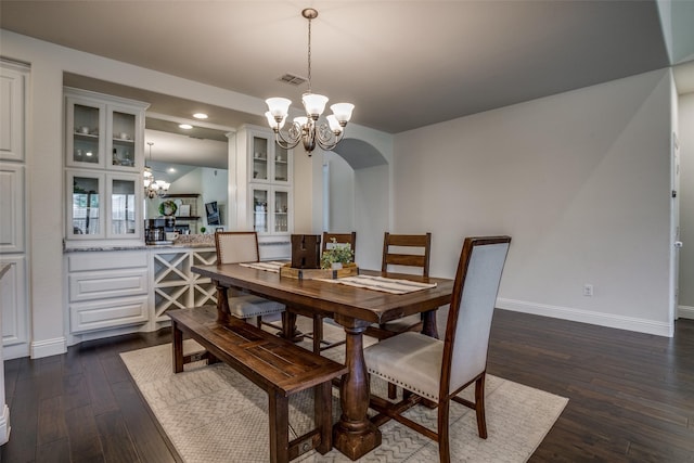 1137 Olympic Dr, Celina, TX 75009 - dining space featuring a chandelier, baseboards, dark wood-style floors, arched walkways, and recessed lighting