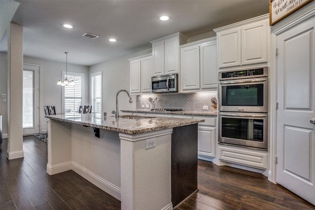 1137 Olympic Dr, Celina, TX 75009 - kitchen with appliances with stainless steel finishes, a sink, dark wood-style flooring, backsplash, and recessed lighting