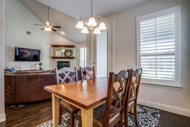 1137 Olympic Dr, Celina, TX 75009 - dining area featuring dark wood finished floors, lofted ceiling, a stone fireplace, a ceiling fan, and baseboards