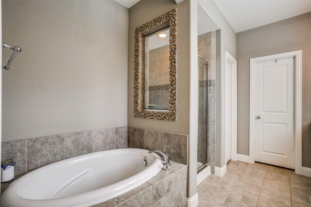 1137 Olympic Dr, Celina, TX 75009 - full bath featuring a bath, a stall shower, baseboards, and tile patterned flooring