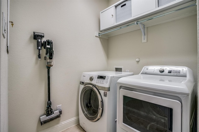 1137 Olympic Dr, Celina, TX 75009 - laundry area with washing machine and dryer and light tile patterned floors