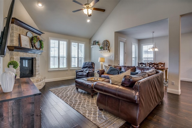 1137 Olympic Dr, Celina, TX 75009 - living room with ceiling fan, baseboards, high vaulted ceiling, a stone fireplace, and a chandelier
