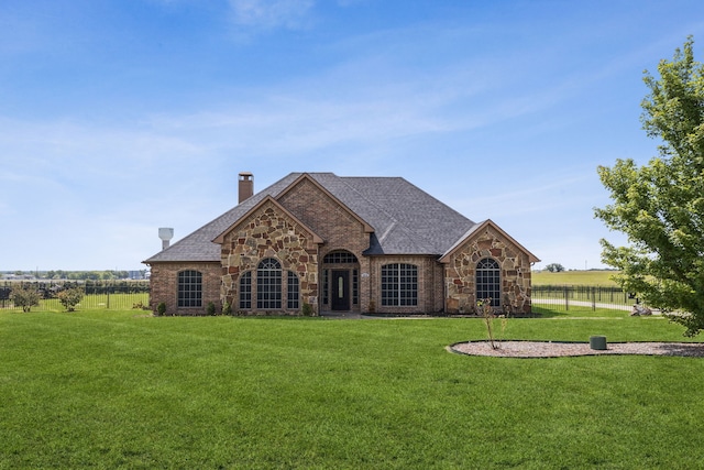 3076 W Alamosa Dr, Terrell, TX 75160 - french country style house featuring stone siding, a chimney, and a shingled roof