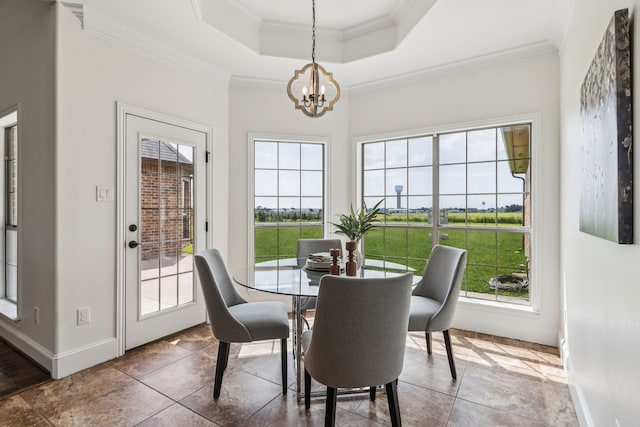 3076 W Alamosa Dr, Terrell, TX 75160 - dining space with a chandelier, a tray ceiling, crown molding, baseboards, and tile patterned floors
