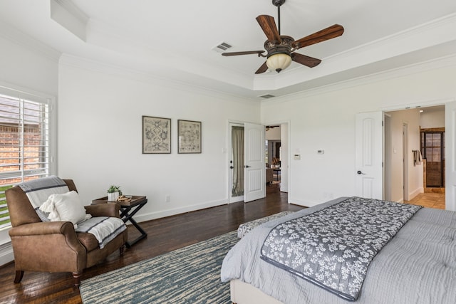 3076 W Alamosa Dr, Terrell, TX 75160 - bedroom featuring a tray ceiling, wood finished floors, ornamental molding, baseboards, and ceiling fan