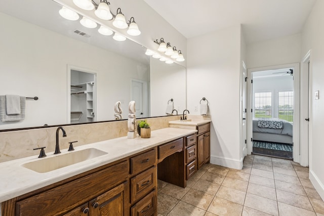 3076 W Alamosa Dr, Terrell, TX 75160 - ensuite bathroom featuring double vanity, tile patterned floors, baseboards, and ceiling fan