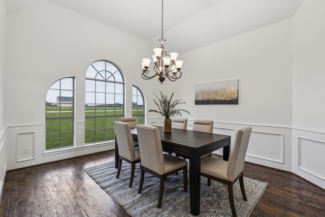 3076 W Alamosa Dr, Terrell, TX 75160 - dining room featuring vaulted ceiling, a chandelier, a decorative wall, wainscoting, and wood finished floors