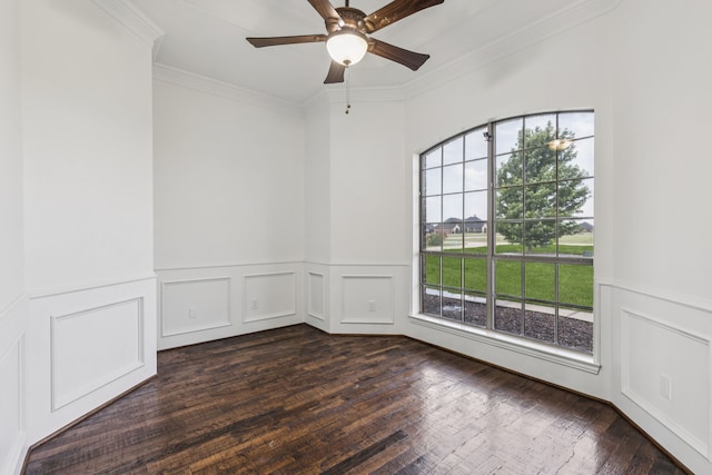 3076 W Alamosa Dr, Terrell, TX 75160 - unfurnished room featuring crown molding, a wainscoted wall, a ceiling fan, a decorative wall, and dark wood-style floors