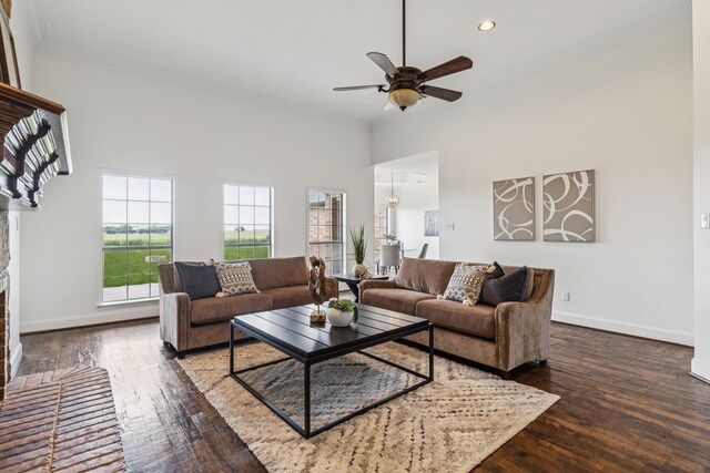 3076 W Alamosa Dr, Terrell, TX 75160 - living area with ornamental molding, hardwood / wood-style flooring, ceiling fan, a fireplace, and baseboards