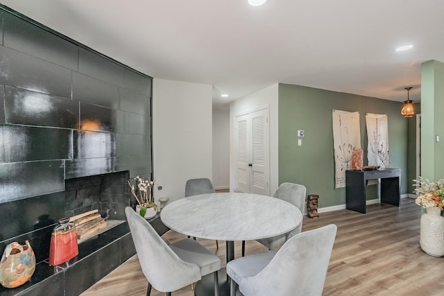 6812 Cumberland Rd, Fort Worth, TX 76116 - dining space with light wood-type flooring, a tiled fireplace, baseboards, and recessed lighting