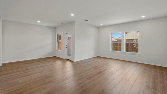 434 Drake Dr, Ferris, TX 75125 - empty room with wood finished floors and recessed lighting