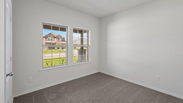 434 Drake Dr, Ferris, TX 75125 - unfurnished room featuring dark carpet and baseboards