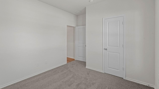 434 Drake Dr, Ferris, TX 75125 - unfurnished bedroom with carpet flooring and baseboards