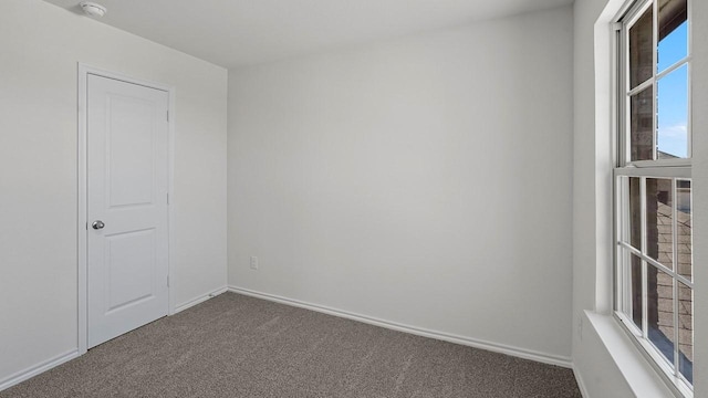 434 Drake Dr, Ferris, TX 75125 - unfurnished room featuring dark carpet and a smoke detector