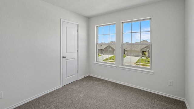 434 Drake Dr, Ferris, TX 75125 - empty room with dark carpet and baseboards
