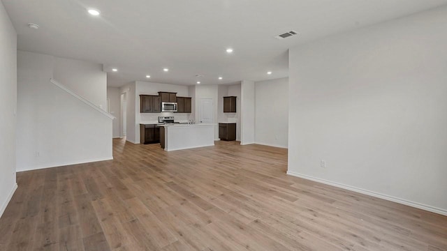 434 Drake Dr, Ferris, TX 75125 - unfurnished living room featuring light wood-type flooring and recessed lighting