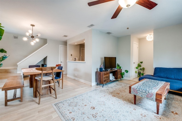 4777 Cedar Springs Rd Unit 8Q, Dallas, TX 75219 - living room featuring a chandelier, wood finished floors, baseboards, and ceiling fan