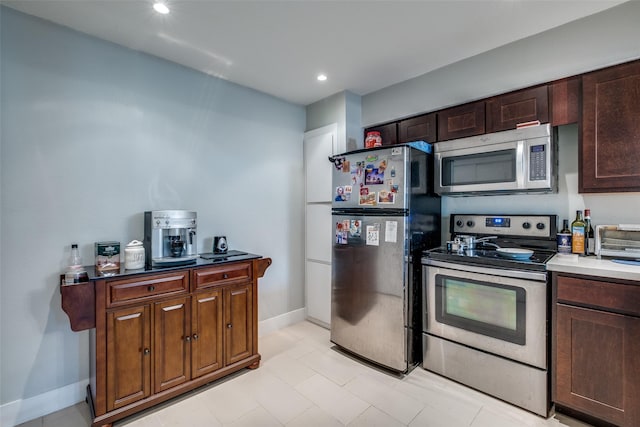 4777 Cedar Springs Rd Unit 8Q, Dallas, TX 75219 - kitchen featuring appliances with stainless steel finishes, baseboards, and recessed lighting