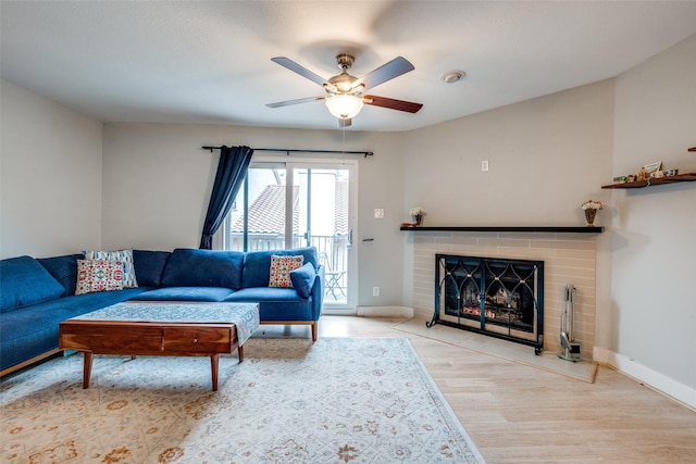 4777 Cedar Springs Rd Unit 8Q, Dallas, TX 75219 - living area featuring ceiling fan, wood finished floors, baseboards, and a fireplace