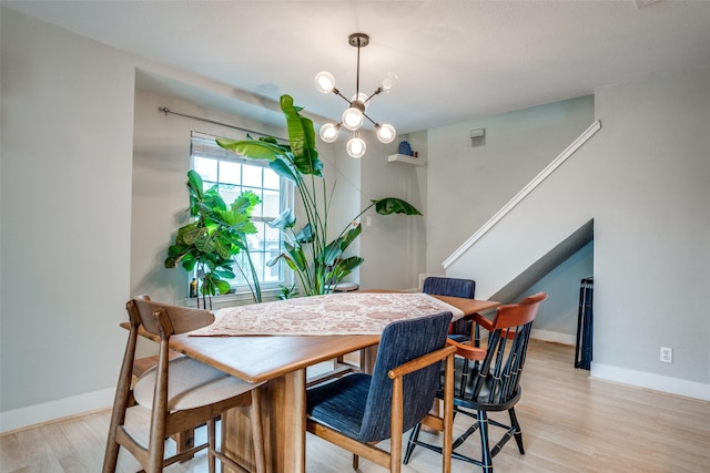 4777 Cedar Springs Rd Unit 8Q, Dallas, TX 75219 - dining space featuring light wood finished floors, baseboards, and a chandelier