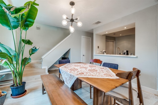 4777 Cedar Springs Rd Unit 8Q, Dallas, TX 75219 - dining room featuring stairway, a chandelier, baseboards, and wood finished floors