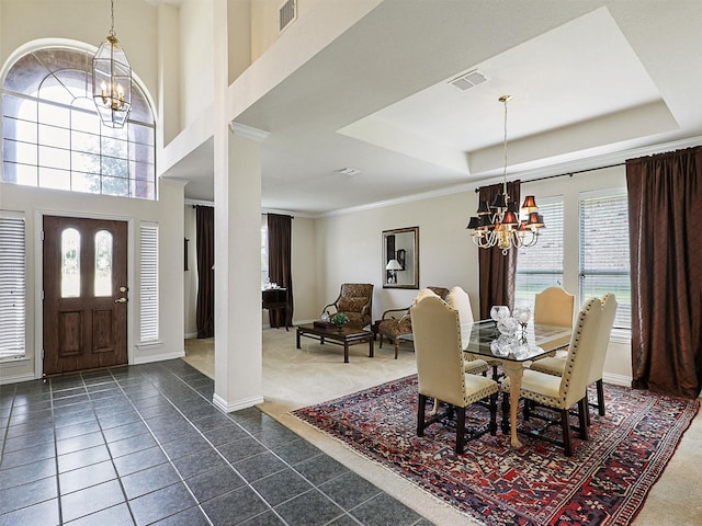 2937 Oakland Hills Dr, Plano, TX 75025 - dining area with a chandelier, dark tile patterned floors, a tray ceiling, dark colored carpet, and ornamental molding
