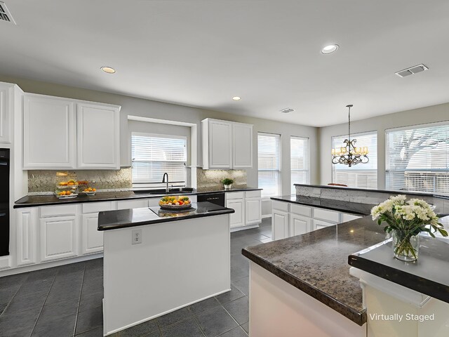2937 Oakland Hills Dr, Plano, TX 75025 - kitchen featuring healthy amount of natural light, a kitchen island, dark countertops, backsplash, and recessed lighting