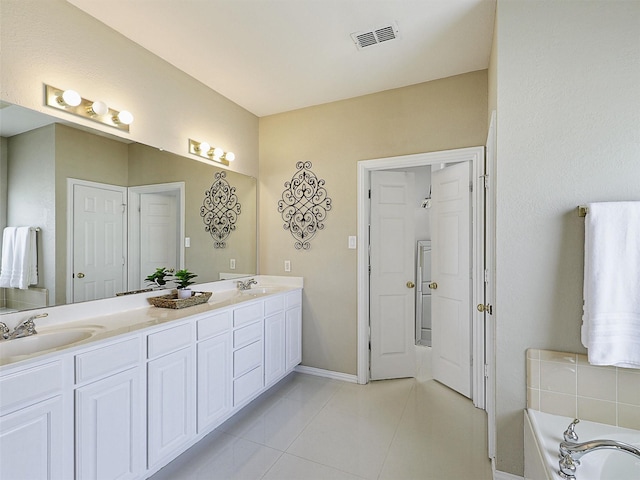 2937 Oakland Hills Dr, Plano, TX 75025 - full bathroom featuring double vanity, tile patterned floors, and a bathtub