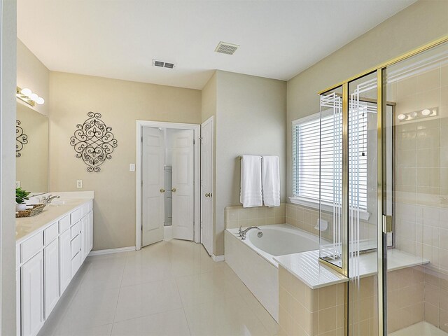 2937 Oakland Hills Dr, Plano, TX 75025 - bathroom featuring a garden tub, double vanity, a shower stall, and tile patterned floors