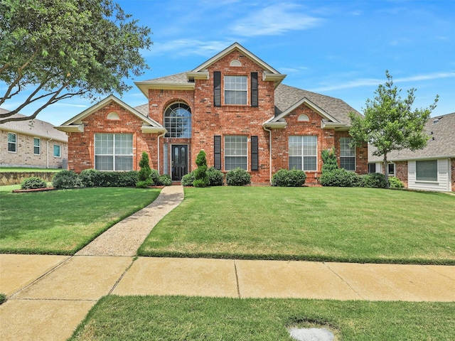 2937 Oakland Hills Dr, Plano, TX 75025 - traditional-style house with brick siding, a front lawn, and roof with shingles