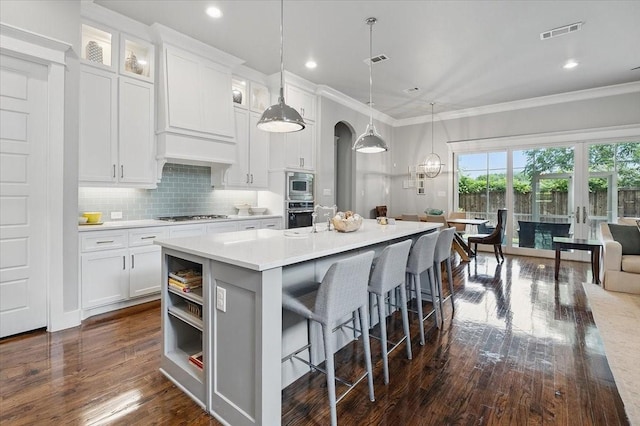3770 W 5th St, Fort Worth, TX 76107 - kitchen featuring appliances with stainless steel finishes, dark wood-style flooring, ornamental molding, light countertops, and white cabinetry