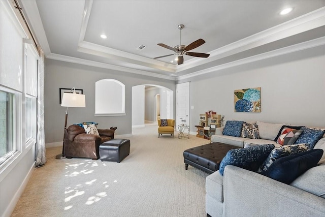 3770 W 5th St, Fort Worth, TX 76107 - living room featuring arched walkways, a raised ceiling, a ceiling fan, carpet floors, and baseboards