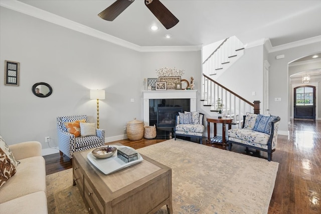3770 W 5th St, Fort Worth, TX 76107 - living room featuring a ceiling fan, arched walkways, baseboards, crown molding, and stairs