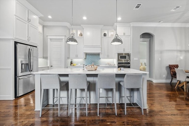 3770 W 5th St, Fort Worth, TX 76107 - kitchen with appliances with stainless steel finishes, ornamental molding, a kitchen island with sink, white cabinets, and a breakfast bar