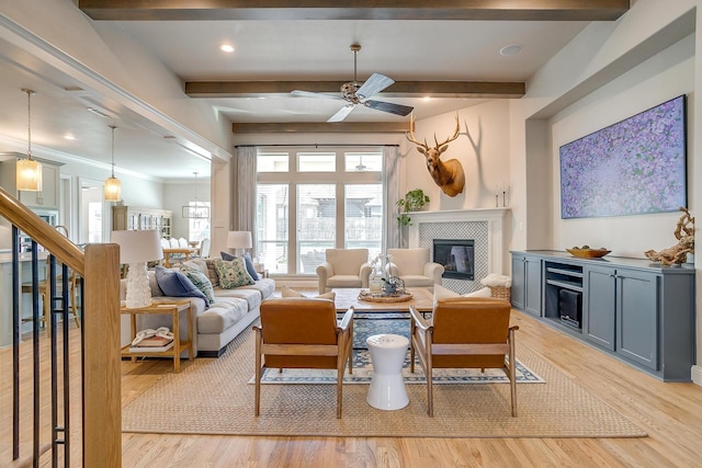 604 Rockfall Way, Aledo, TX 76008 - living area featuring a tile fireplace, light wood-style floors, ceiling fan, and beam ceiling