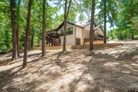 303 Llano Bnd, Holly Lake Ranch, TX 75765 - view of yard featuring stairway and a deck