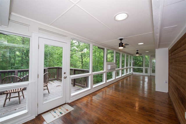 303 Llano Bnd, Holly Lake Ranch, TX 75765 - unfurnished sunroom with a wooden deck, a ceiling fan, and wood finished floors