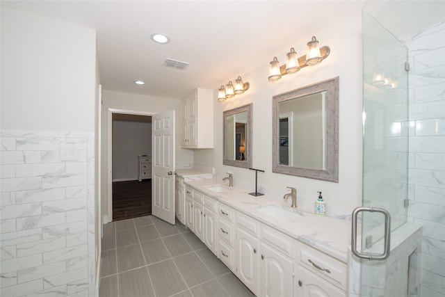 303 Llano Bnd, Holly Lake Ranch, TX 75765 - full bath featuring double vanity, a shower stall, recessed lighting, and tile patterned floors