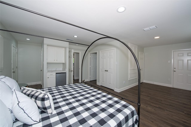 303 Llano Bnd, Holly Lake Ranch, TX 75765 - bedroom with fridge, dark wood-style flooring, and recessed lighting