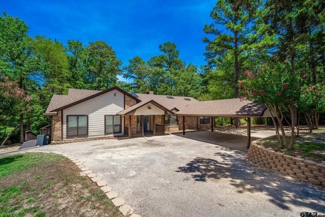 303 Llano Bnd, Holly Lake Ranch, TX 75765 - ranch-style home featuring a carport, driveway, and brick siding