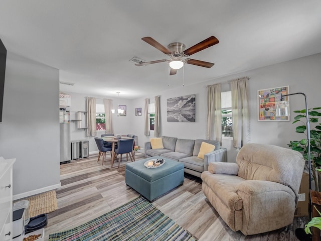 7831 San Jose Ave, Dallas, TX 75241 - living room with healthy amount of natural light, a ceiling fan, and light wood-style floors