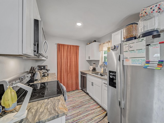 7831 San Jose Ave, Dallas, TX 75241 - kitchen with appliances with stainless steel finishes, a sink, and white cabinetry