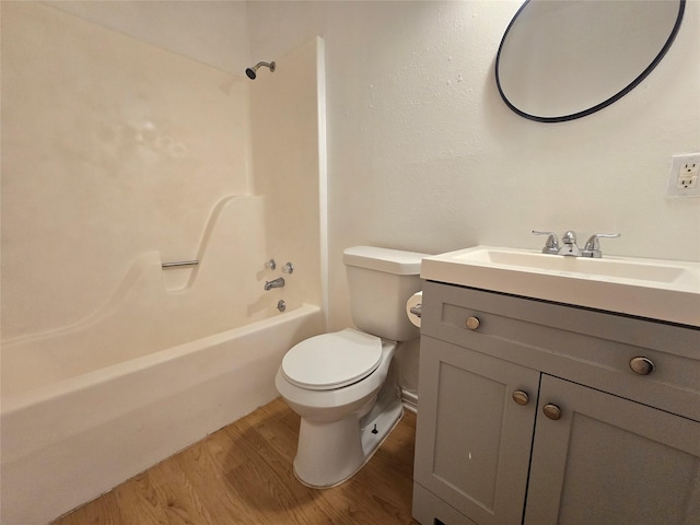 201 Paschal, Troup, TX 75789 - bathroom with wood finished floors, toilet, vanity, and tub / shower combination