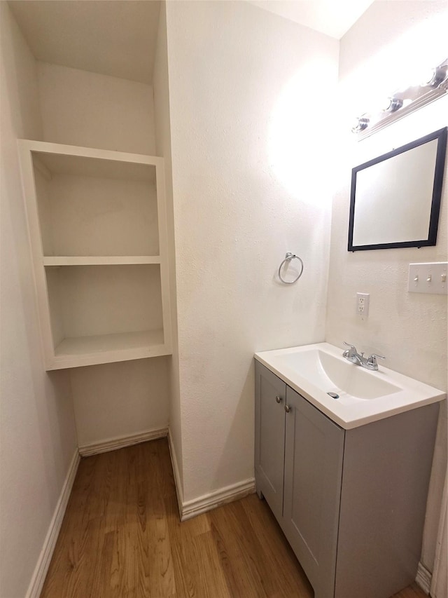 201 Paschal, Troup, TX 75789 - bathroom featuring wood finished floors, vanity, and baseboards