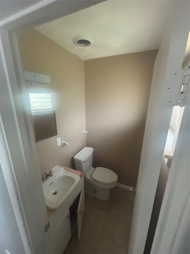 2730 Eastbrook Dr, Mesquite, TX 75150 - half bath with vanity, tile patterned flooring, toilet, and baseboards