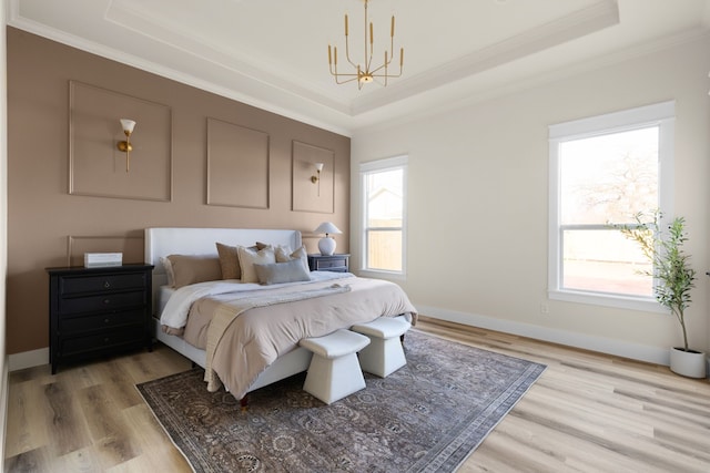 1228 Gould Ave, Fort Worth, TX 76164 - bedroom featuring a chandelier, a tray ceiling, light wood-style flooring, ornamental molding, and multiple windows